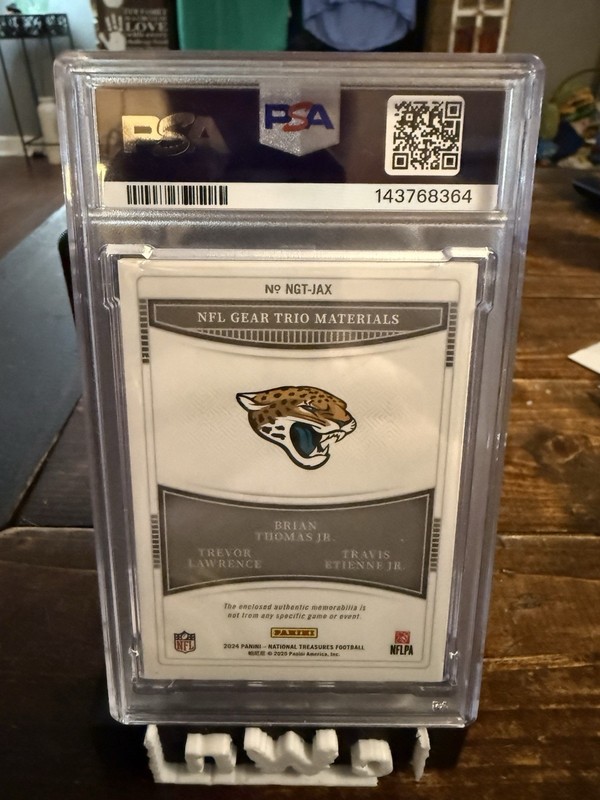 2024 National Treasures NFL Gear Trio Materials Lawrence / Etienne / BTJ RC 1/1 view 2