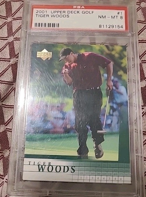 Tiger Woods x (2) 2001 Upper Deck Rookie Card, 1 PSA 8, plus 1 raw, excellent. view 1