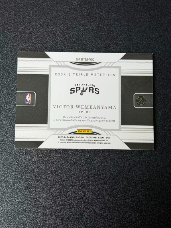 2023 National Treasures #RTM-VIC Victor Wembanyama Rookie Triple Materials /99 view 2