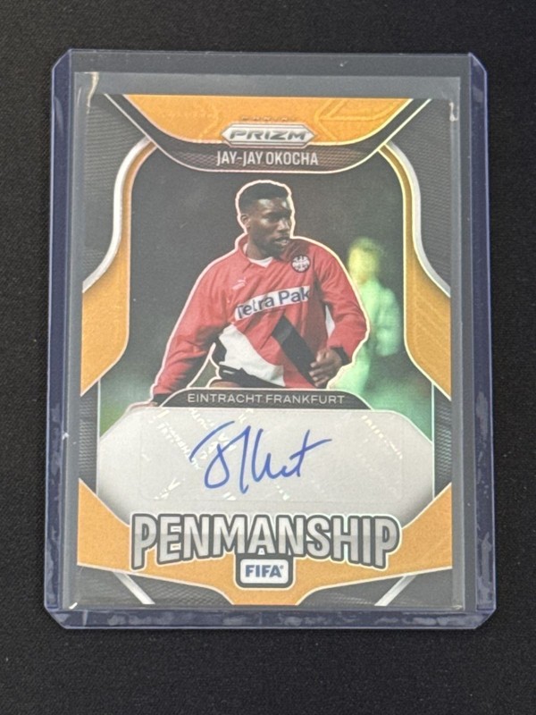 Jay Jay Okocha 2025-26 Panini Prizm FIFA Penmanship Auto Orange Prizm #P-JJO 2/5
